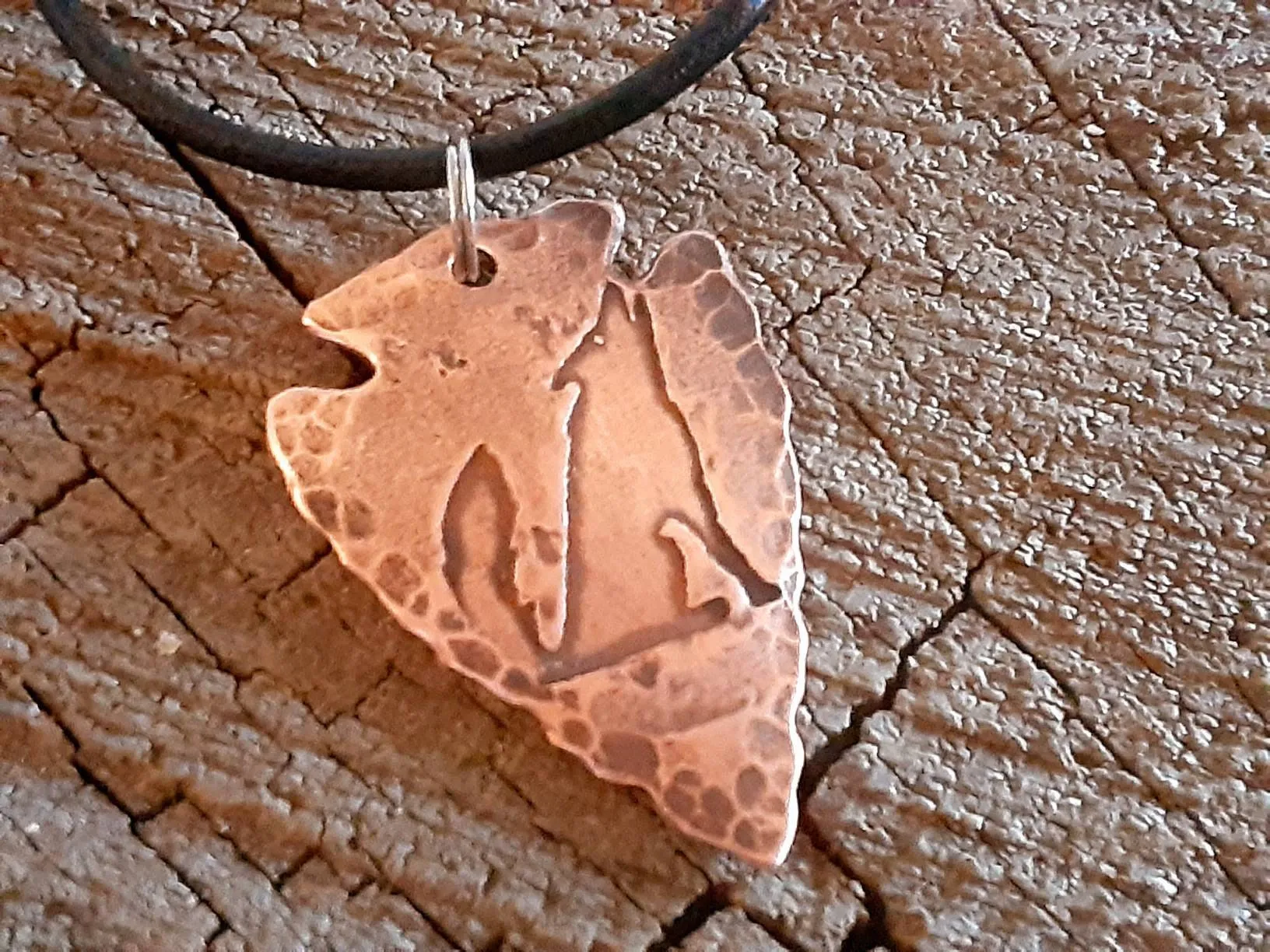Men's copper arrowhead necklace with howling coyote and an adjustable leather cord